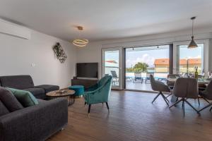 salon z kanapą, stołem i krzesłami w obiekcie Villa Manhattan w mieście Dobrinj