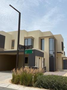 une maison avec un panneau de rue devant elle dans l'établissement 5 bedroom Villa - Dubai Hills, à Dubaï