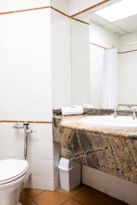y baño con lavabo, aseo y espejo. en Willows Garden Hotel Potchefstroom, en Potchefstroom