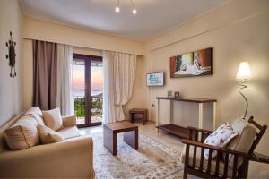 a living room with a couch and a table at MEGA AMMOS HOTEL in Syvota