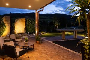 an outdoor patio with a table and chairs and a table at Gasthof - Restaurant Hubertushof in Peilstein im Mühlviertel