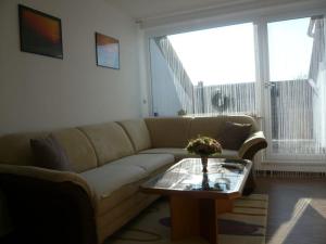 a living room with a couch and a coffee table at Am Moos in Isny im Allgäu