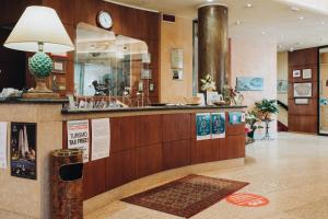 a lobby of a hotel with a counter and a lobby at Hotel Alan in Anzola dell'Emilia