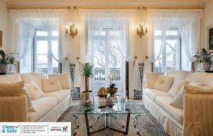 a living room with white couches and a glass table at Casa dell'Arte Club House in Lisbon
