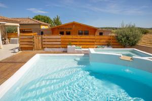 a swimming pool in the backyard of a house at Le chalet aux Etoiles Spa & Sauna in Pézenas