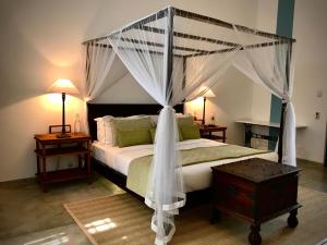 A bed or beds in a room at The Postcard Galle
