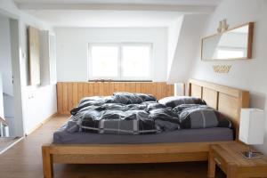 a bedroom with a bed with a wooden headboard and pillows at Ferienhaus Deko-Scheune in Naila