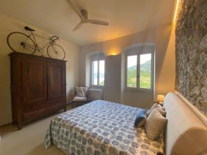 a bedroom with a bed and a bike on the wall at Ca de Marge in Corniglia