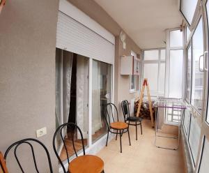a room with chairs and a table and a window at PERLES Apartament KORCE in Korçë