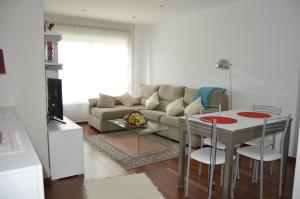 a living room with a couch and a table and chairs at Apartamento con vistas en Cambados in Cambados