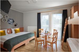 Postel nebo postele na pokoji v ubytování JUFA Familienresort Kempten im Allgäu