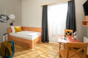 Postel nebo postele na pokoji v ubytování JUFA Familienresort Kempten im Allgäu