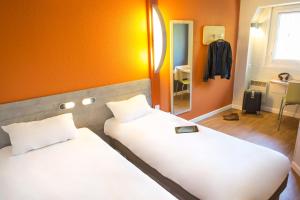Postel nebo postele na pokoji v ubytování ibis budget Vienne Sud