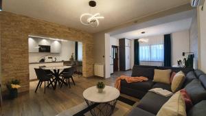 a living room with a couch and a table at Apartments Lucić in Slunj