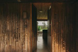 an open hallway with wooden walls and a doorway at Santa Barbara Eco-Beach Resort in Ribeira Grande