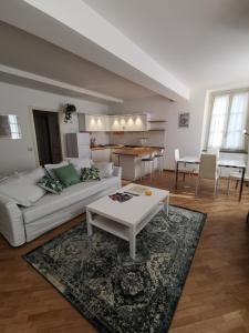 salon z białą kanapą i stołem w obiekcie Parma Central Apartments w mieście Parma