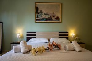 a bedroom with a large bed with two lamps and a painting at Irini Apartments in Kavála