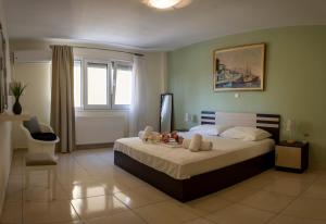 a bedroom with a bed with stuffed animals on it at Irini Apartments in Kavála