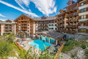 an aerial view of a resort with a swimming pool at Residence Arc 1950 Le Village - maeva Home in Arc 1950
