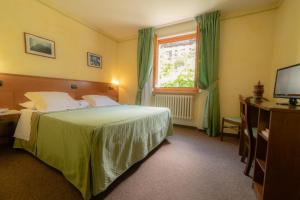 Ένα ή περισσότερα κρεβάτια σε δωμάτιο στο Hotel Beau Sejour Pré-Saint-Didier