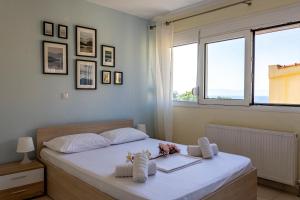 a bedroom with a bed with towels on it at Irini Apartments in Kavála