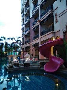 a swimming pool with a slide in front of a building at Wannara Hotel Hua Hin in Hua Hin
