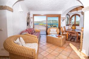 a living room with a couch and a table at villa smeralda in Cannigione +10 photos