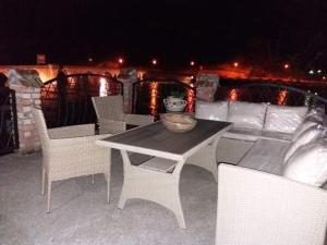 a table and chairs and a couch on a patio at Apartmani Memory in Višegrad