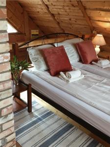 a bed with two pillows on it in a room at Namelis Atokvėpis in Čiuiniukai