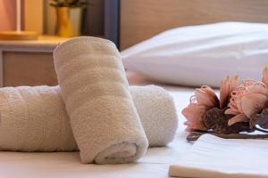 a roll of toilet paper sitting on top of a bed at Irini Apartments in Kavála