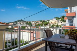 a balcony with a table and a view of a city at Irini Apartments in Kavála