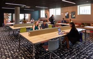 a group of people sitting at tables in a room at Mama Shelter Luxembourg in Luxembourg