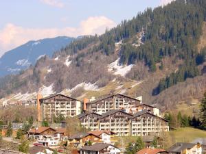 a large building in front of a mountain at Disentiserhof C502 in Disentis