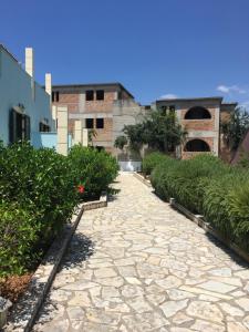 a stone path in front of a building at Georges Estates Hotel in Stoupa