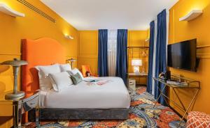 a hotel room with a bed and a flat screen tv at Villa Brown Moshava - a member of Brown Hotels in Jerusalem