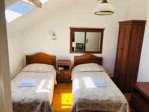 a bedroom with two beds and a mirror at Hotel Mateo in Stopnica