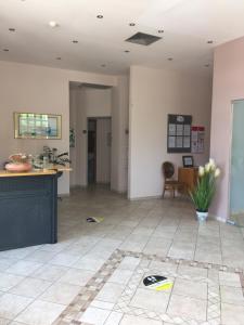 a living room with a counter and a table at Georges Estates Hotel in Stoupa