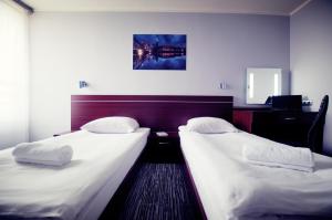 two twin beds in a hotel room with at Hotel Śląsk in Wrocław