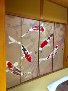 a room with four kites painted on the wall at Yufu Inn in Yufu