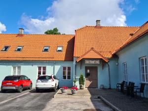 two cars parked in a parking lot in front of a building at Kuressaare Central Hostel in Kuressaare