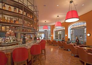 a restaurant with red chairs and a bar at InterContinental Boston by IHG in Boston