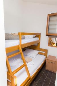 a bunk room with two bunk beds and a mirror at Rooms Hercegovka in Čapljina