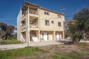 a large building with stairs on the side of it at Finata Studios in Kavos