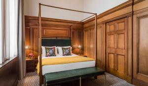 a bedroom with a bed and a dresser at Kimpton Clocktower, an IHG Hotel in Manchester