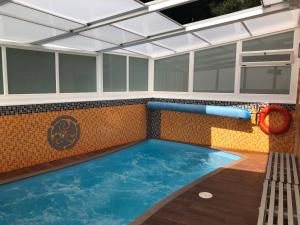 an indoor swimming pool with a inflatable at Apartamentos Trisquel in Sanxenxo