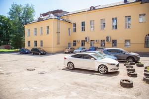 a white car parked in front of a building at Lux apartment on Nezalezhnoi Ukrаiny 39-B near Bulvar Shevchenko in Zaporozhye