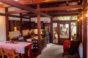 a kitchen with a table and a kitchen with a table and chairs at Grancharova Guest House in Bansko