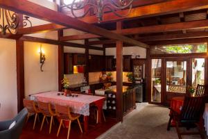 a kitchen with a red table and chairs in a room at Grancharova Guest House in Bansko