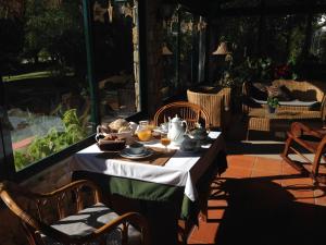 a table with food on it on a patio at Quinta Verde Sintra - Casa de Campo in Sintra