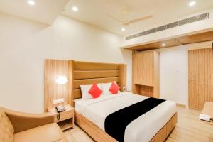 a bedroom with a large bed and a couch at INN THE CENTRE in Nellore